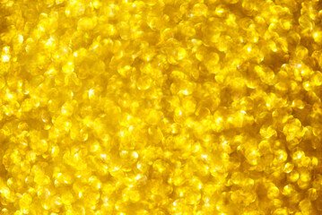 Abstract background texture of golden glitter and bokeh