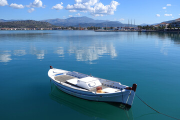 Fototapeta premium Traditional fishing boats anchored in small port of Nafplio city, Argolida, Peloponnese, Greece
