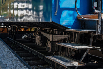 train wagon on rails, blue metal, ladder, entrance to railroad car