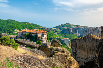 Monastery Meteora Greece. Stunning summer panoramic landscape. View at mountains and green forest...