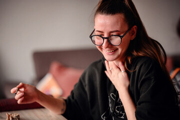 An artist's joyful expression captured mid-creation, her glasses framing the delight of artistic...