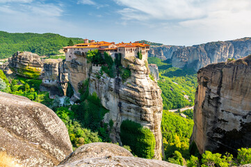 Monastery Meteora Greece. Stunning summer panoramic landscape. View at mountains and green forest...