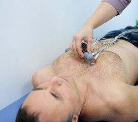 Heart cardiogram in the hands of a doctor close-up. Cardiologist is studying the testimony of an...
