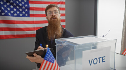 A bearded man with glasses noting beside a ballot box with an american flag background in a voting...