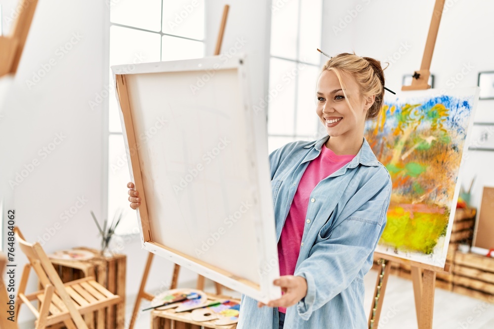 Poster young caucasian woman artist smiling confident looking draw at art studio