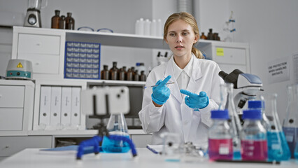 A young woman scientist works with chemicals in a laboratory, showcasing research and healthcare...
