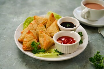 Homemade mini cocktail samosa | Indian appetizer served with ketchup and tamarind sauce