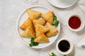 Homemade mini cocktail samosa | Indian appetizer served with ketchup and tamarind sauce