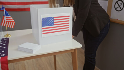 Woman voting in an american election booth with a united states flag behind her.