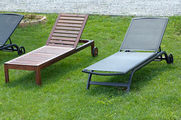 Two Different Sun Bed Loungers at Grass in Garden