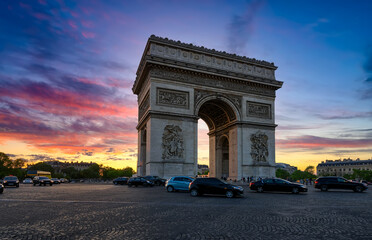 Paris Arc de Triomphe (Triumphal Arch) in Champs Elysees at sunset, Paris, France. Cityscape of Paris. Architecture and landmarks of Paris