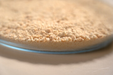 Ground cookies in glass bowl. Cooking Salted Caramel Chocolate Cold Cake Series.