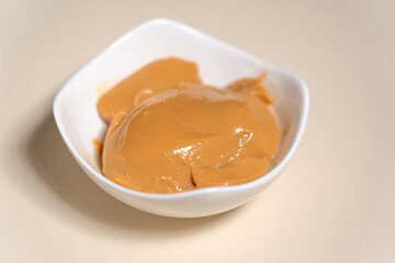 Bowl with sweetened condensed milk caramel sauce. Cooking Salted Caramel Chocolate Cold Cake Series.