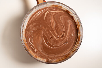 Making sauce with melting chocolate and thickened cream. Cooking Salted Caramel Chocolate Cold Cake...