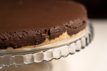 Chilled cake on pressed glass cake stand ready to decorate. Cooking Salted Caramel Chocolate Cold...