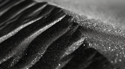 Close-up of a mountain of shiny black sand - obrazy, fototapety, plakaty