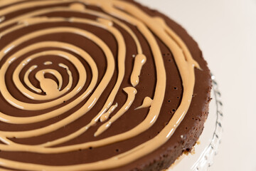 Cake decorating. Spiral from caramel sauce. Making Salted Caramel Chocolate Cold Cake Series.