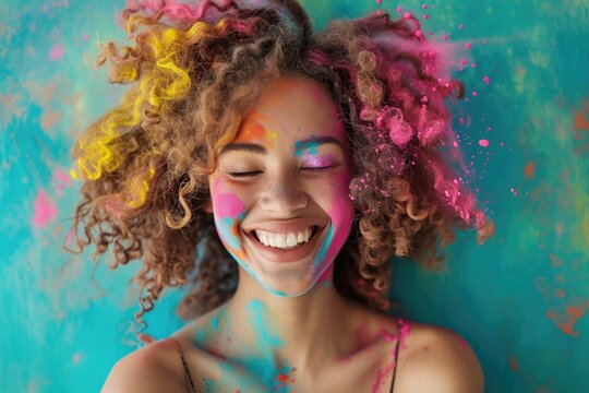 Joyful woman covered in colorful paint at festival