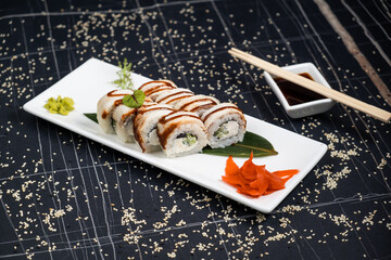 Green dragon sushi roll with eel, avocado, cucumber, wasabi and ginger.