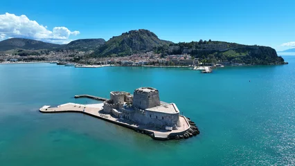 Foto auf Alu-Dibond Aerial drone photo of castle of Bourtzi built at sea a popular attraction in city of Nafplio former capital of Greece as seen in the morning with nice white clouds and deep blue sky, Argolida, Greece © aerial-drone