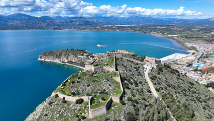 Aerial drone photo of beautiful landmark castle of Palamidi built uphill overlooking iconic city of Nafplio in a nice spring morning with white clouds and deep blue sky, Argolida, Peloponnese, Greece