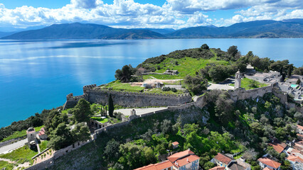 Fototapeta na wymiar Aerial drone photo of iconic Acronafplia fortress overlooking old city of Nafplio below famous castle of Palamidi as seen in a spring morning with beautiful clouds and deep blue sky, Argolida, Greece