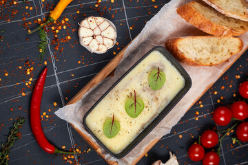 Fresh homemade chicken liver pate in ceramic bowl or ramekin and baguette slices with pate on the serving board, selective focus.