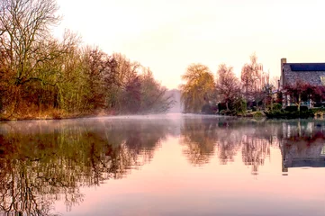 Papier Peint photo Destinations Sun rise view of a pond in Delft in april with a  low and nice haze on the water