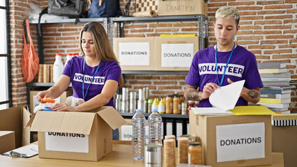 Man and woman volunteers working together at charity center