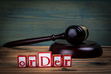 ORDER. Red alphabet letters and judge's gavel on wooden background. laws and justice concept