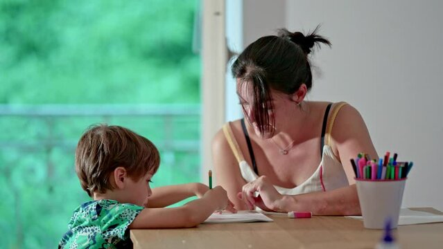 Mom Provides Guidance To Youngster During Alphabet Learning Task