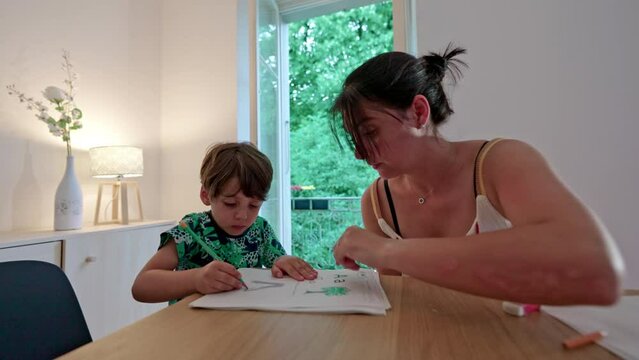 Little Boy Does Homework Of Painting Letters To Train Precision And Dexterity With Mother’s Help