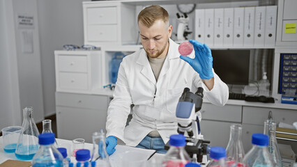 Bearded young man examines synthetic meat in modern laboratory setting