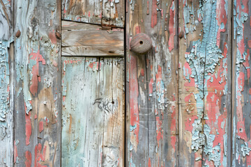 Weathered wooden door with peeling paint, old rustic building, conveying a sense of history and authenticity, imperfect yet charming, realistic photography