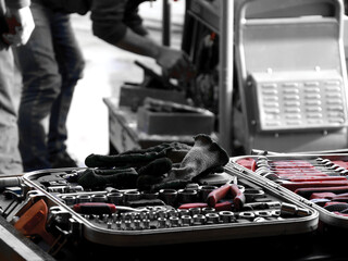 mechanics tools with the machine being worked on in the background