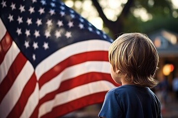 Young boy with patriotic spirit gazing at american flag during independence day celebration