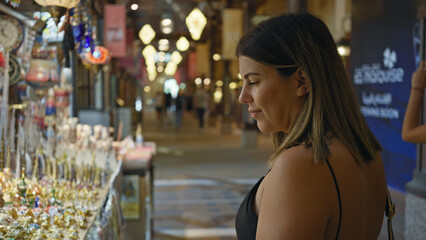 A young brunette woman shops at a traditional souk in dubai, showcasing culture, tourism, and lifestyle.