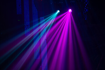 Fototapeta na wymiar Multi-colored laser beams from stage spotlights.