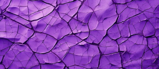 An image showing a close-up of a purple wall with visible cracks against a dark black background
