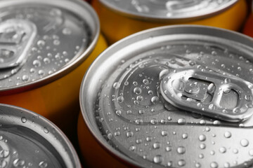 Energy drinks in wet cans, closeup. Functional beverage