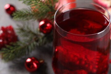 Aromatic Christmas Sangria drink in glass on table, closeup. Space for text