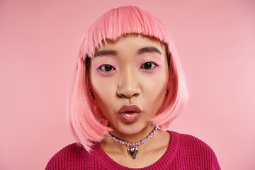 close up lovely asian woman in 20s with nose piercing and pink hair surprising and looking to camera