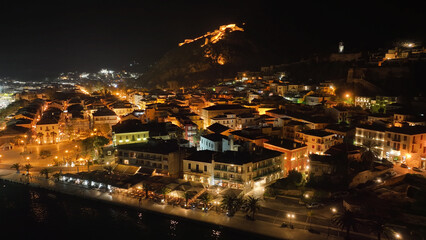 Aerial drone night shot of illuminated historic old city of Nafplio former capital of Greece, Argolida, Peloponnese