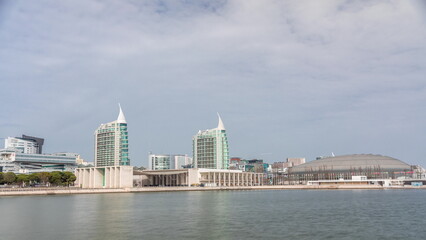 Modern tall residential and office buildings reflecting in the water timelapse hyperlapse in Lisbon, Portugal.