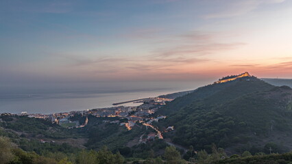 Panorama showing aerial view of Sesimbra Town and Port day to night timelapse, Portugal.