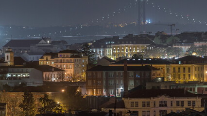 Aerial view towards Barrio Alto and 25th of April Bridge night timelapse, Lisbon, Portugal.