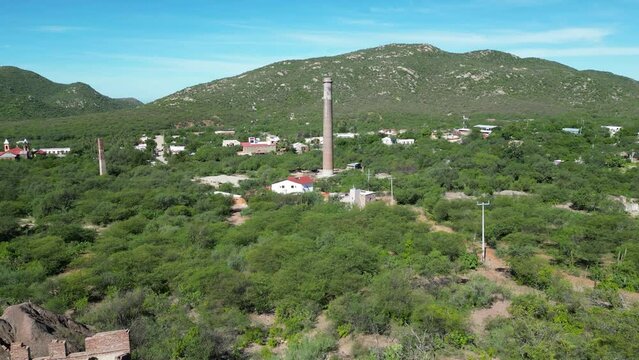 Drone approach view of an old industrial chimney called "La Ramona" located in El Triunfo, Baja California Sur, Mexico