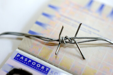 Concept Barbed wire and European passport - Border security
