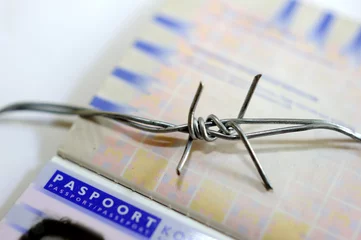 Fototapeten Concept Barbed wire and European passport - Border security © Richard