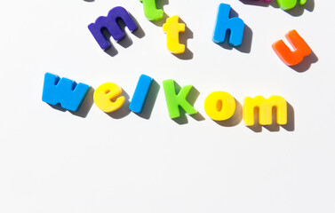 Fridge magnet letters spell "welkom" welcome in Dutch.